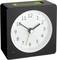 A black analogue alarm clock shows 10:10. A green switch is located at the top.