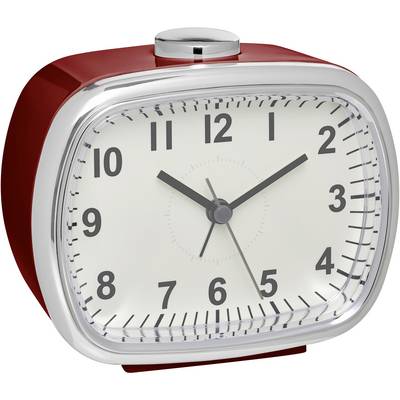 A red, rectangular table clock shows 10:10.