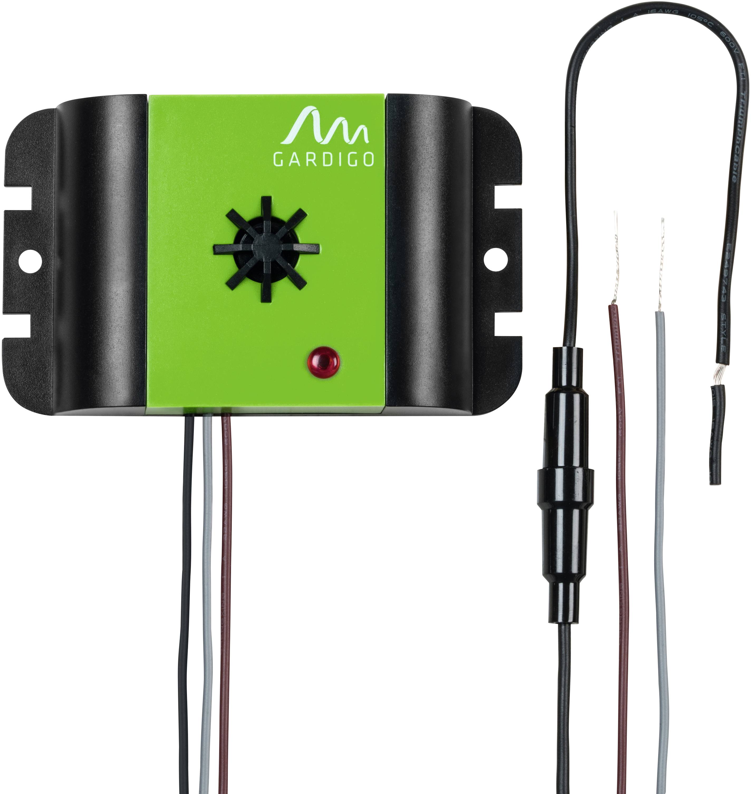 A green Gardigo device for repelling mice and insects, with speaker opening and red LED indicator. Connected wires visible.