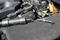 'Faulty ignition coils placed on an engine cover, with visible parts of the engine in the background.'