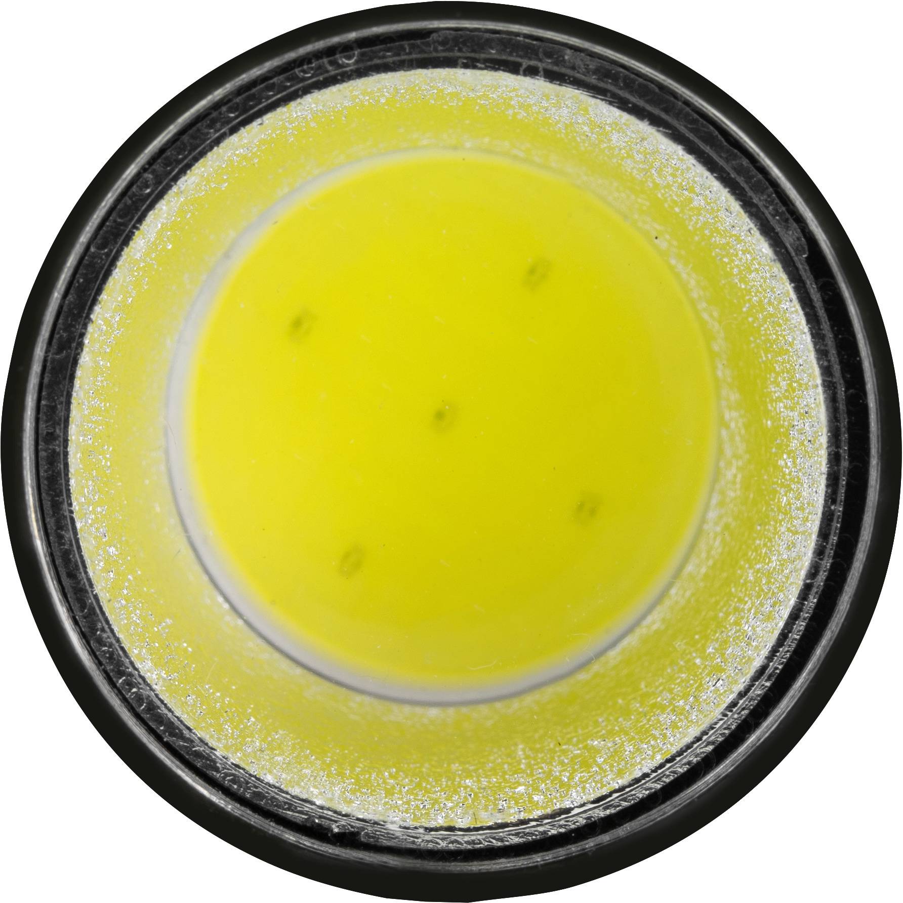 Dose filled with yellow powder, evenly distributed. Top-down view, round container with black rim.