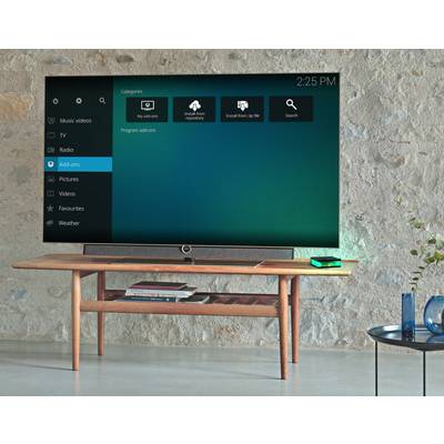 'Smart TV displays user interface with categories such as Music Tracks, Pictures and Films on blue screen. Time shown top right: 14:25.'