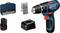 Cordless drill set with drill machine, charger, battery, bit set and carry case. 'Bosch' branding visible on all components.