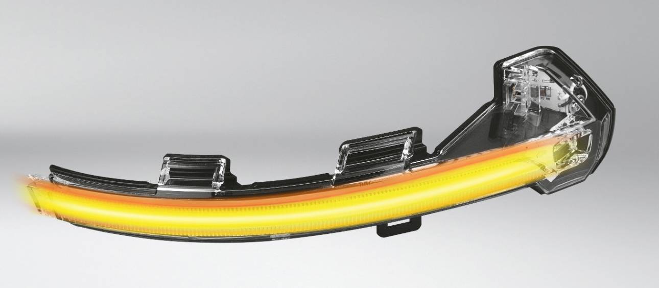 LED rear light unit with a curved, multi-coloured light strip in yellow and red, on a grey background.