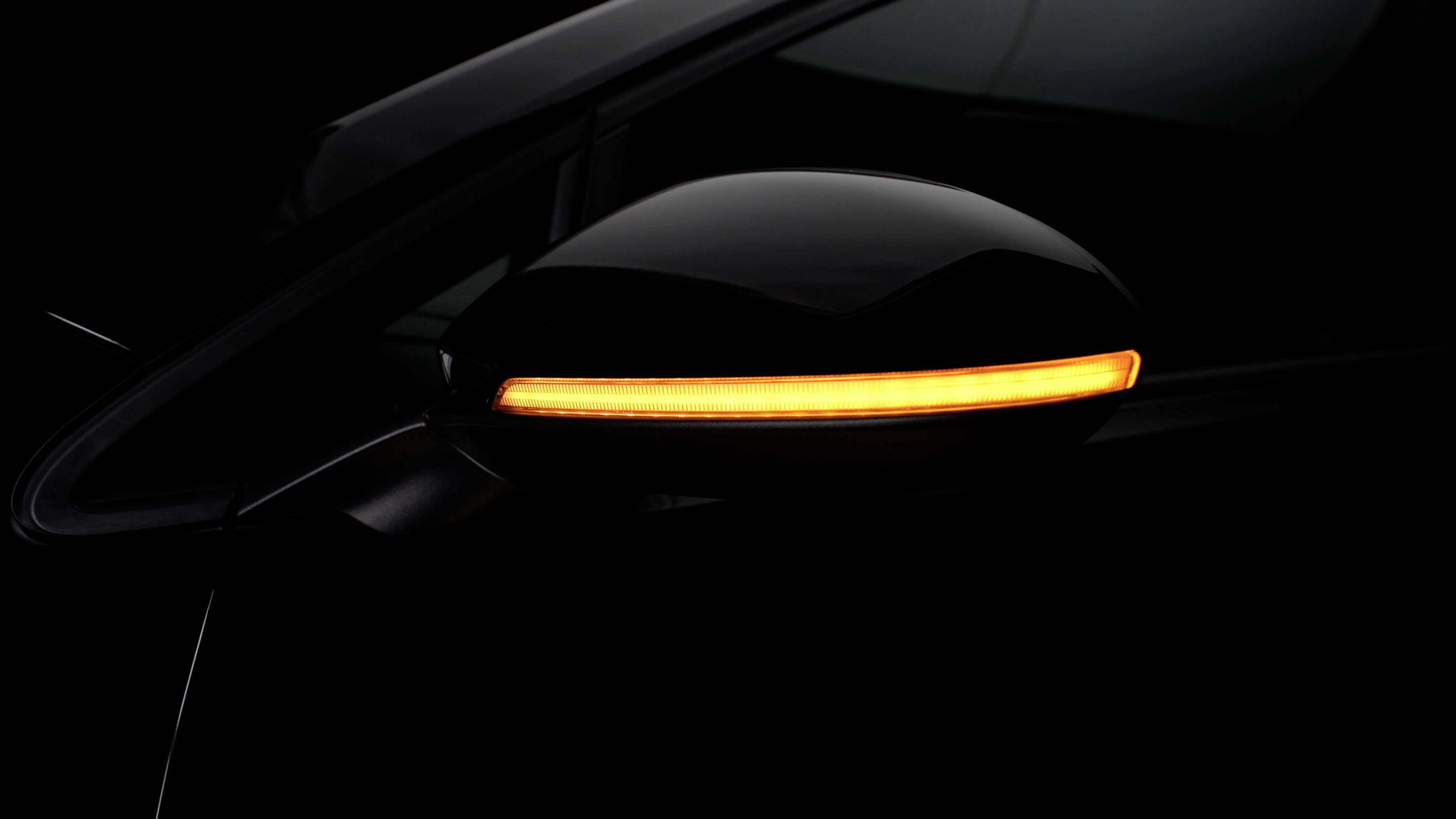 'A car's indicator flashes orange in the darkness.'
