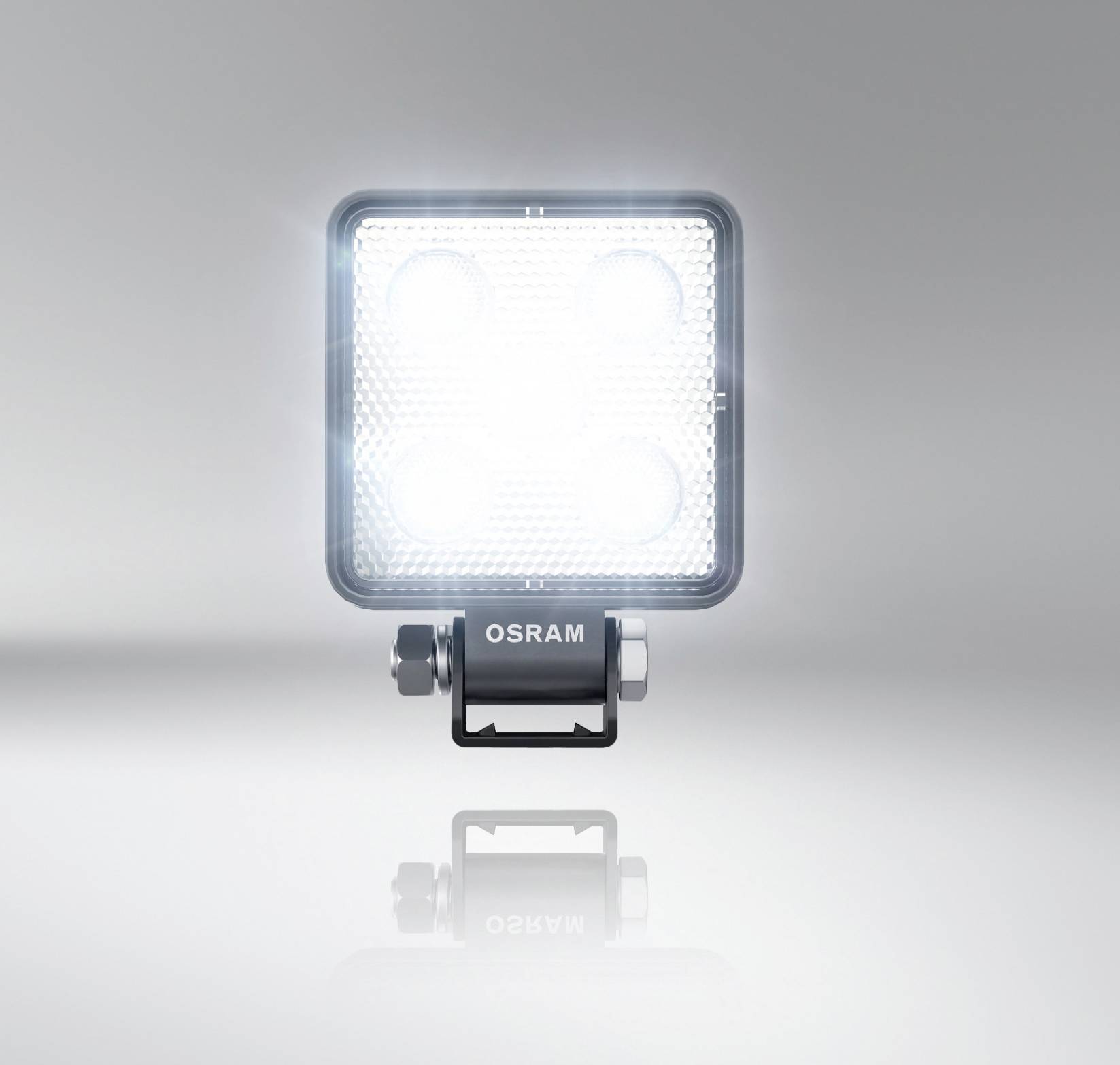 A rectangular LED headlight from OSRAM illuminates brightly against a grey background.