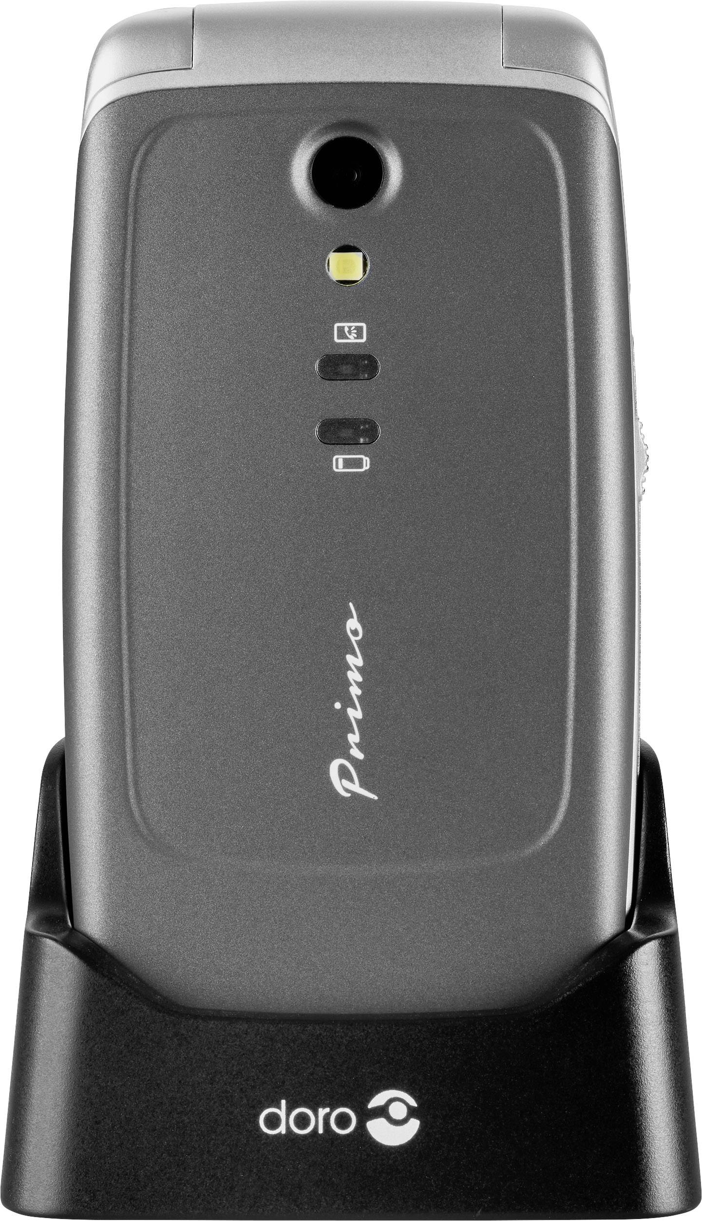 A Doro mobile phone standing upright in a charging cradle, with a flip design, featuring a camera and the brand name 'Primo'.