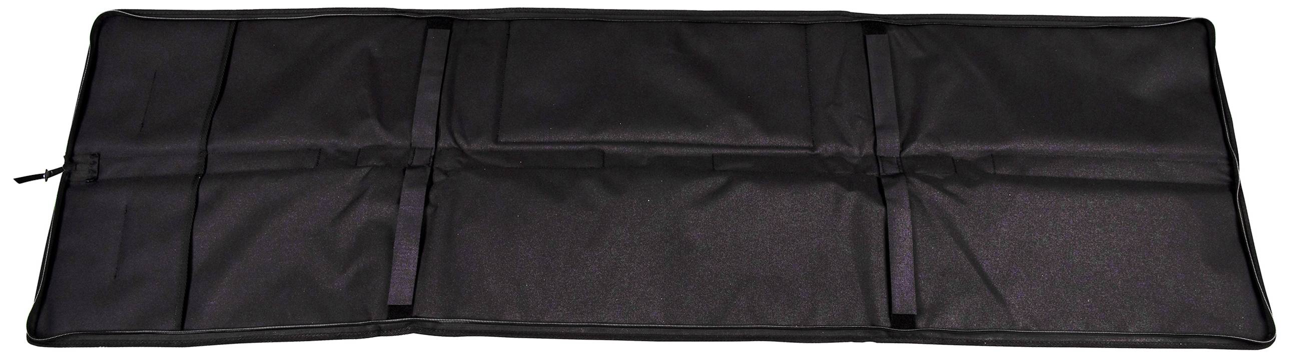 A flat, spread-out black case with multiple compartments and a zip on the left-hand side.