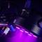 A purple LED spotlight is illuminating a dark room. Cables are connected, with the 'Cameo' brand visible.