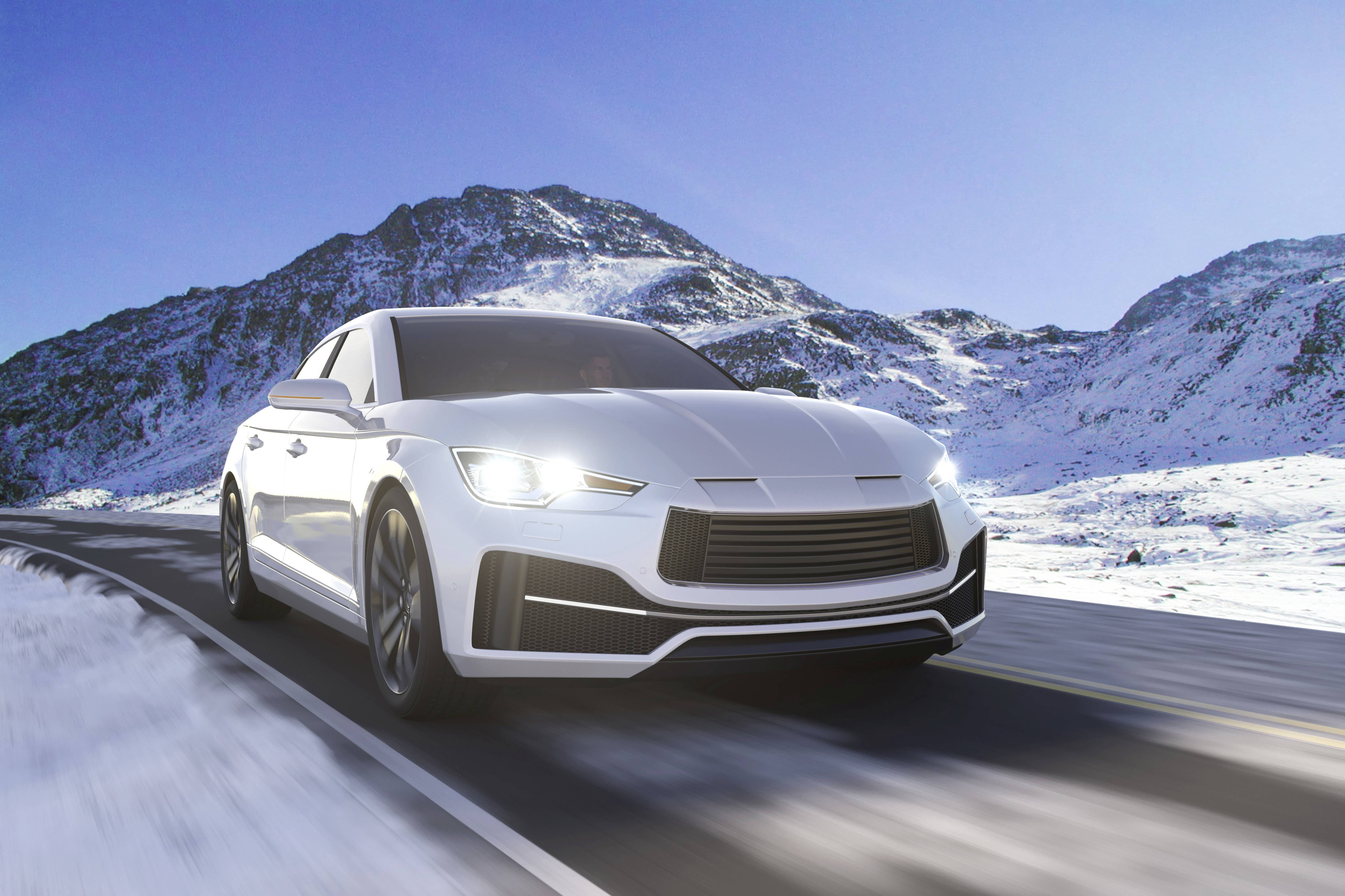 A white car drives along a winding road through a snow-covered mountain landscape under sunny weather.