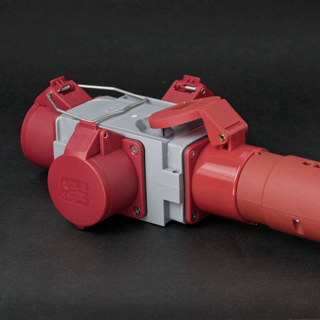 'Close-up of a red industrial connector on a grey background.'