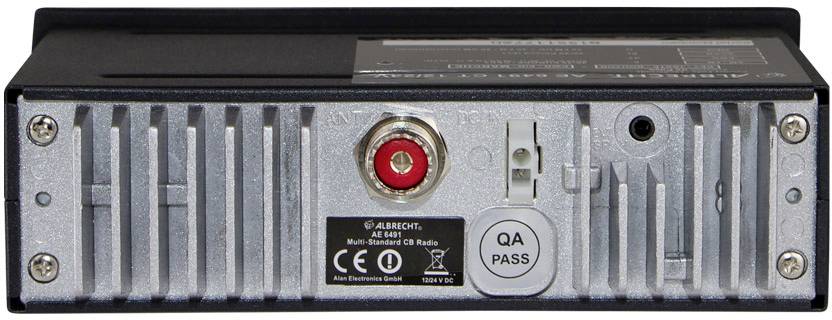 Back of an electronic device with heat sinks, a red connection in the centre, additional ports, and CE and QA certification.