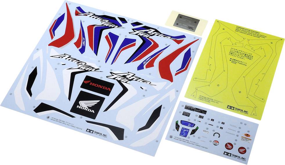 Decal sheet for model building with Honda logo and red, blue, and white patterns. Beside it a yellow sheet with instructions.