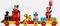 A LEGO train with Disney characters: Mickey as the train driver, Pluto on a wagon with presents, Minnie with balloons.