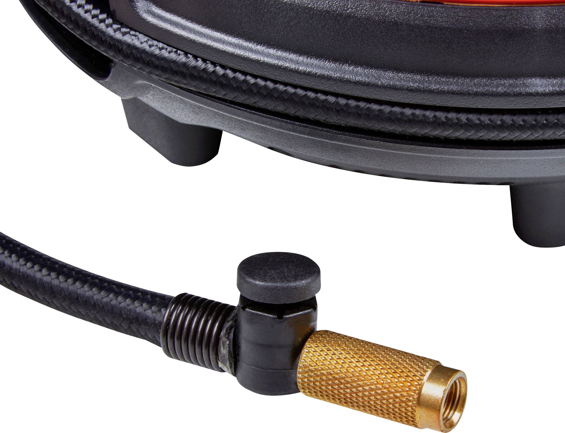 Close-up of a black hose end with a gold-coloured connector and a black lever, likely belonging to a piece of equipment.