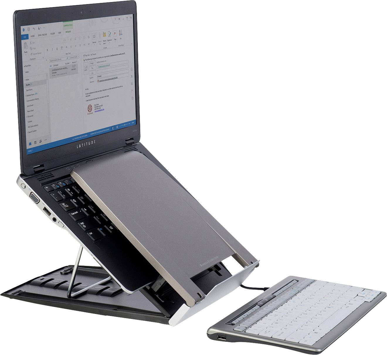 A laptop with an open screen on a stand. The keyboard is detachable and lies separately in front of the laptop.
