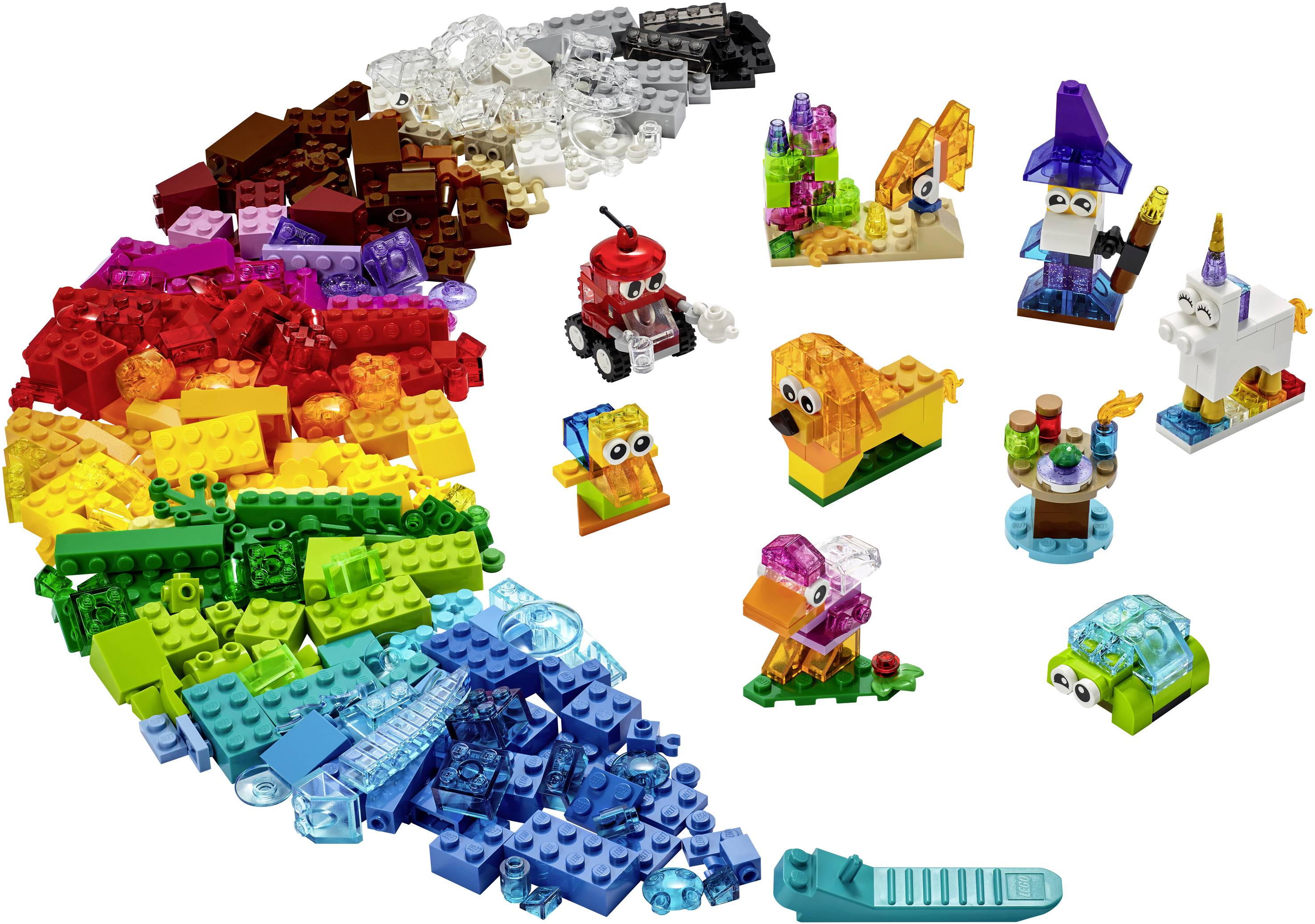 A variety of colourful building blocks and figures constructed from them, including a car, a dog, and a wizard, on a white background.