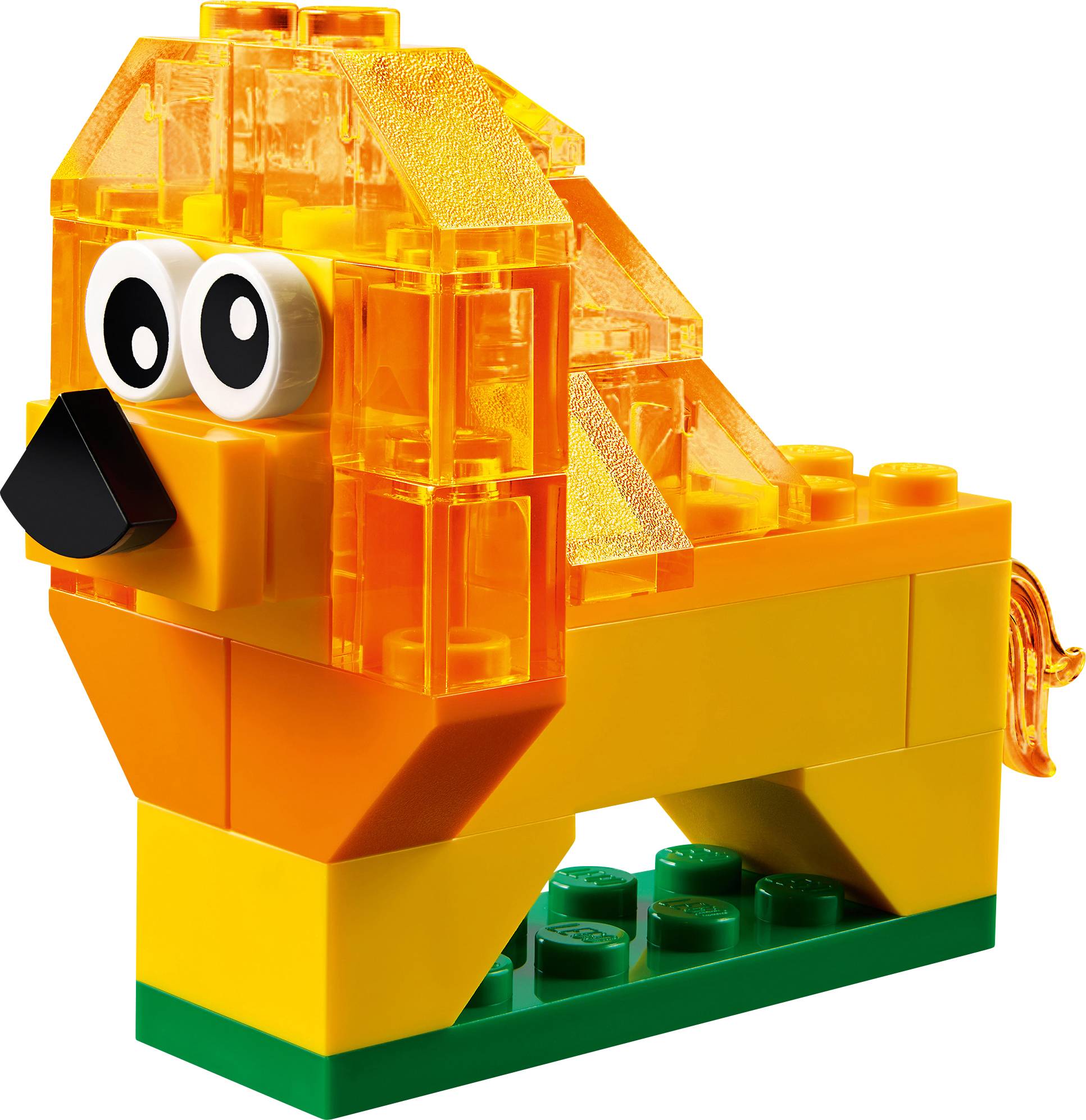A lion built from yellow and orange building blocks with black eyes and a small black nose, positioned on a green base.
