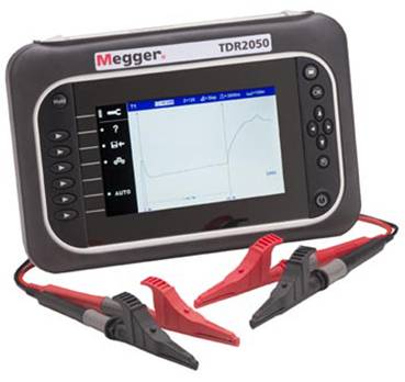 A cable testing device 'Megger TDR2050' with a large display shows a graphical analysis. Two test clips are connected.