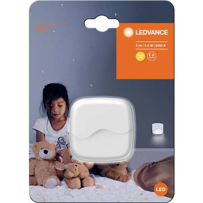 Packaging for an LED night light lamp. A child sits in the darkness, surrounded by cuddly toys. The packaging displays luminosity specifications.