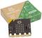 A microcontroller board with two buttons and LED displays is shown in front of a cardboard box printed with 'BBC micro:bit' and 'Create Learn Code'.