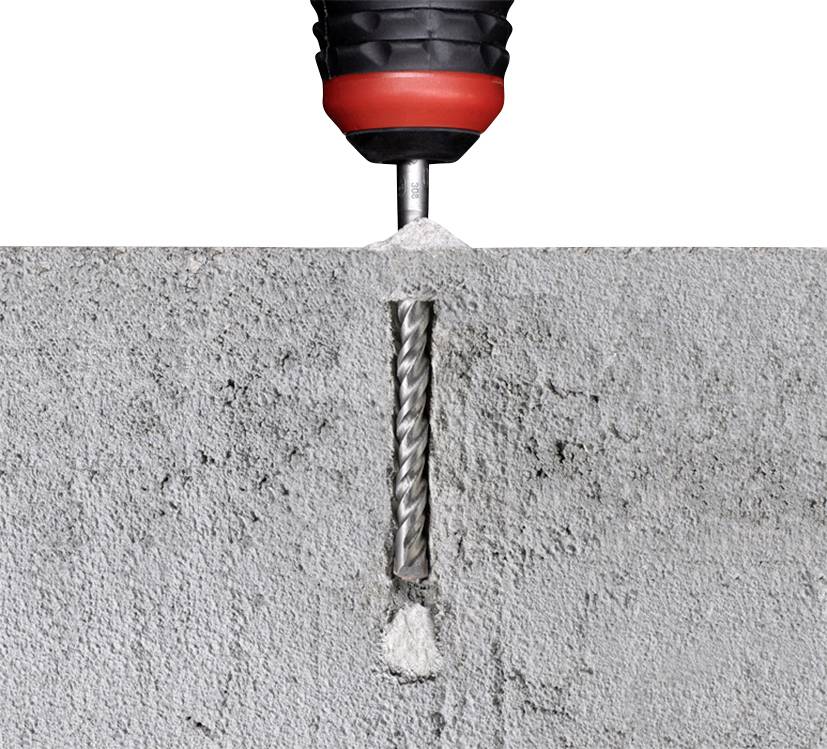 A drill penetrates a concrete wall.