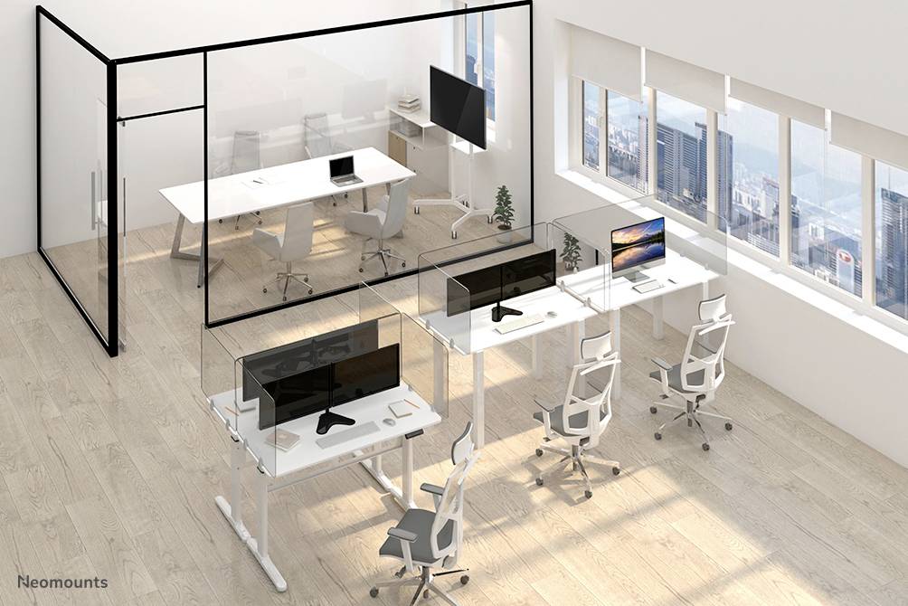 Office with glass walls. Three modern desks with screens and chairs are arranged in rows. Large meeting table in the background.