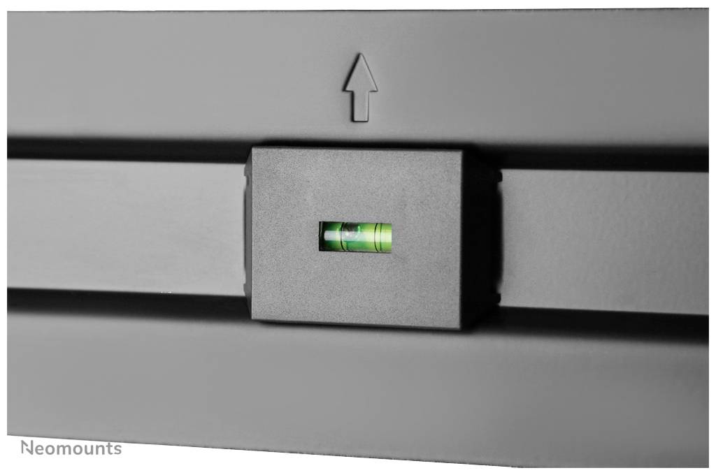 Green spirit level in a black holder against a grey background. Arrow pointing upwards.
