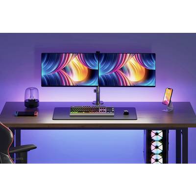A desk with two large monitors, a colourful keyboard, a mouse, and a smartphone on a stand. Colourful LED lighting in the background.