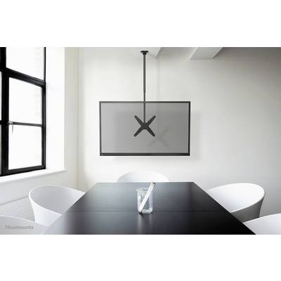 A minimalist meeting room with a table, four white chairs and a flat-screen monitor mounted on the ceiling.