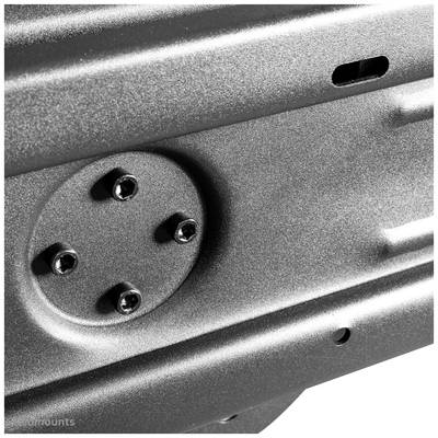 Close-up of a metallic structure with several screws fastened to a circular plate.