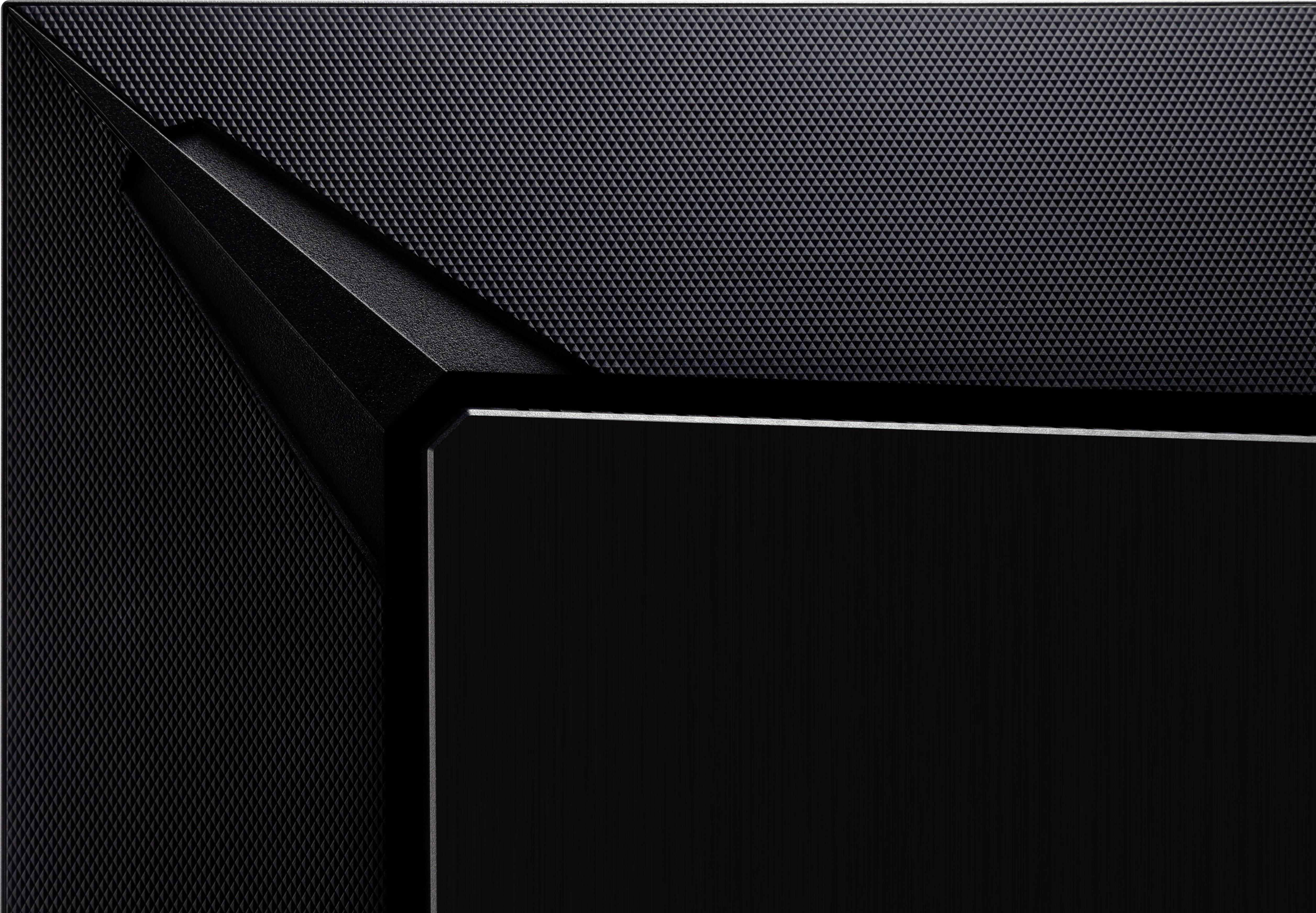 Close-up of a black, modern, angular structure with a fine perforated surface.