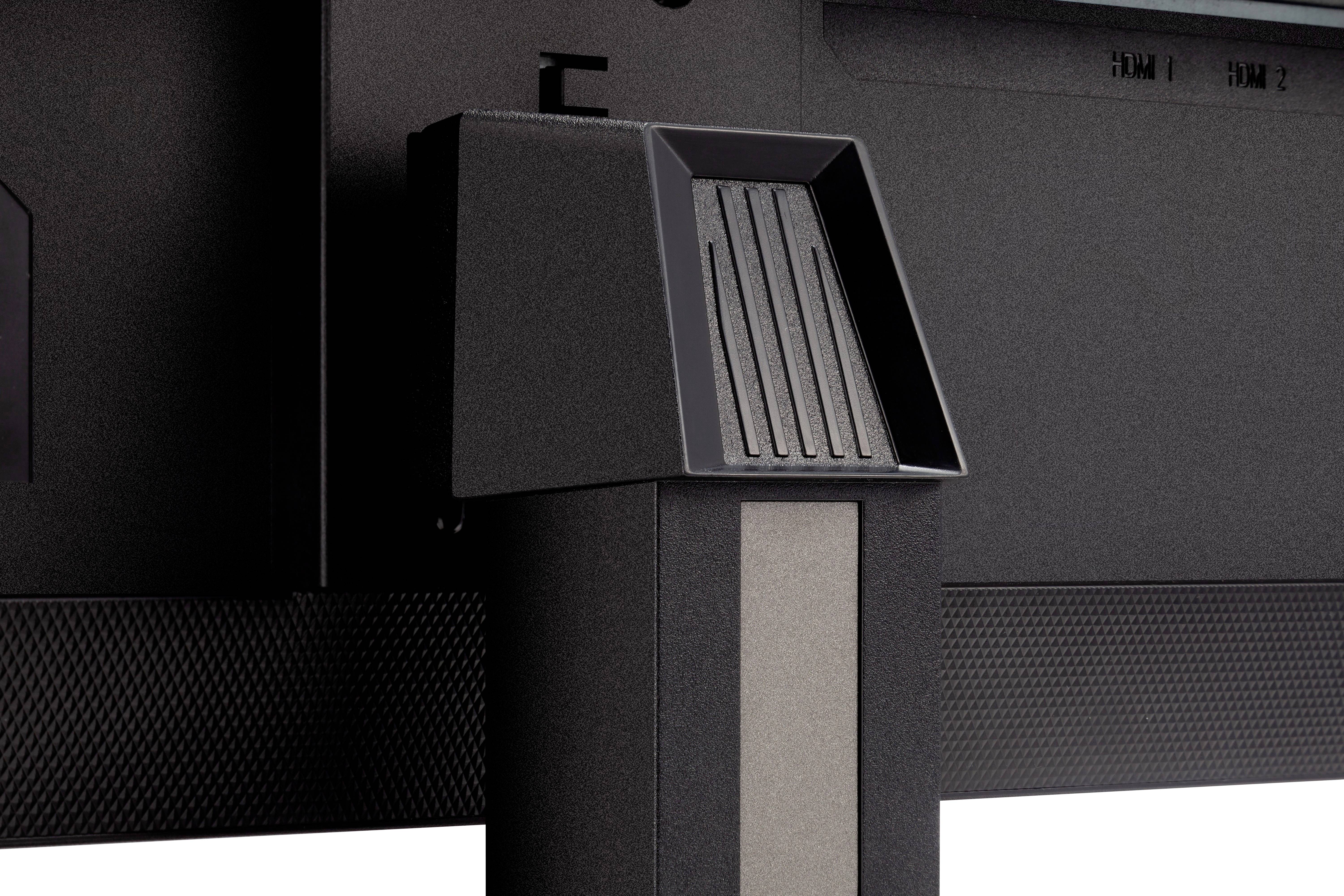 Close-up of a television or monitor stand. It shows the mounting bracket and the textured surface of the base.