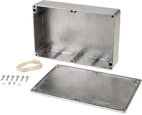 Aluminium metal enclosure with removed lid. Screws and a sealing ring are placed beside it. Suitable for electrical installations.