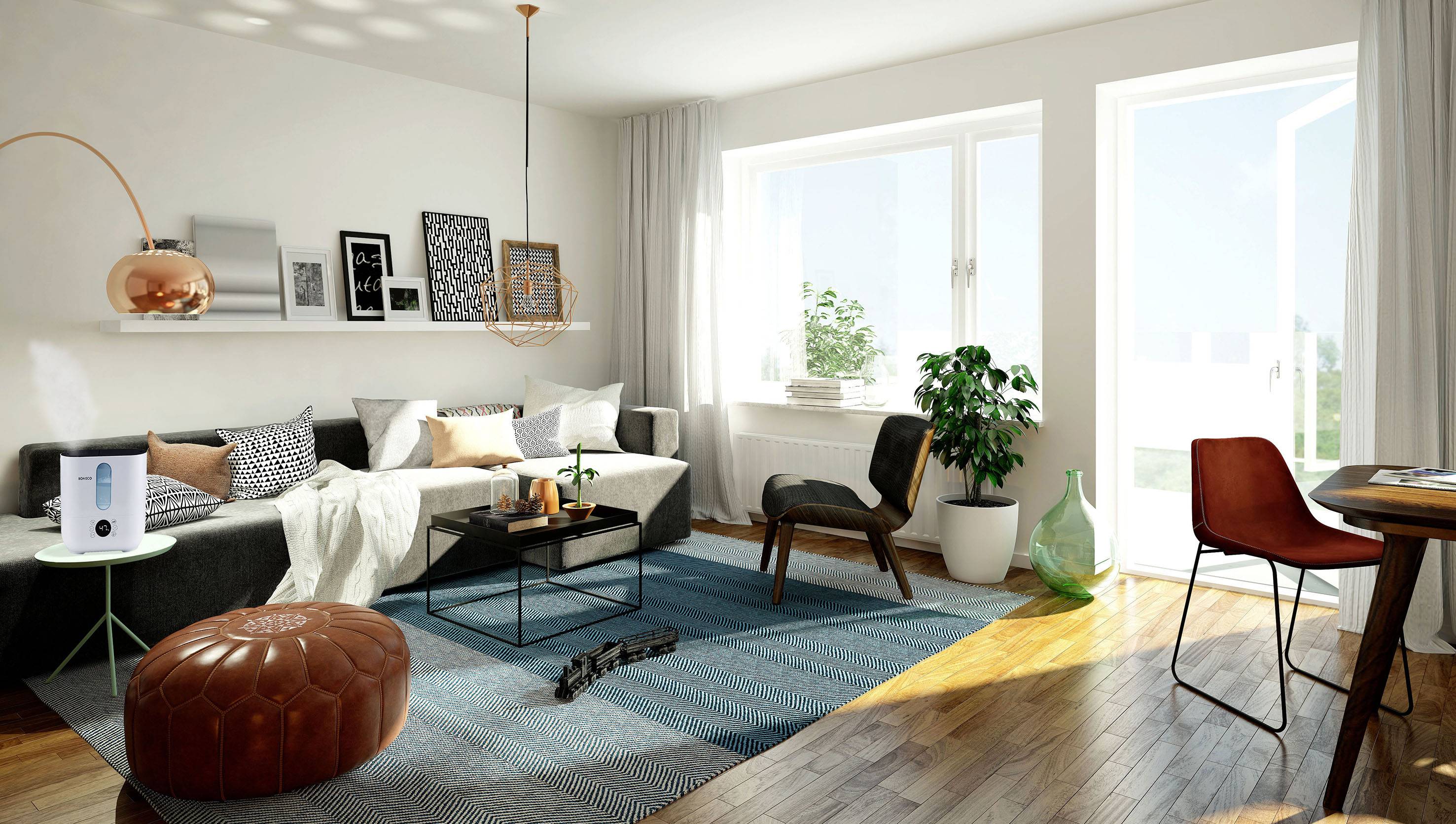 A bright living room with modern decor: sofa, side table, rug and plants. Daylight floods through large windows.