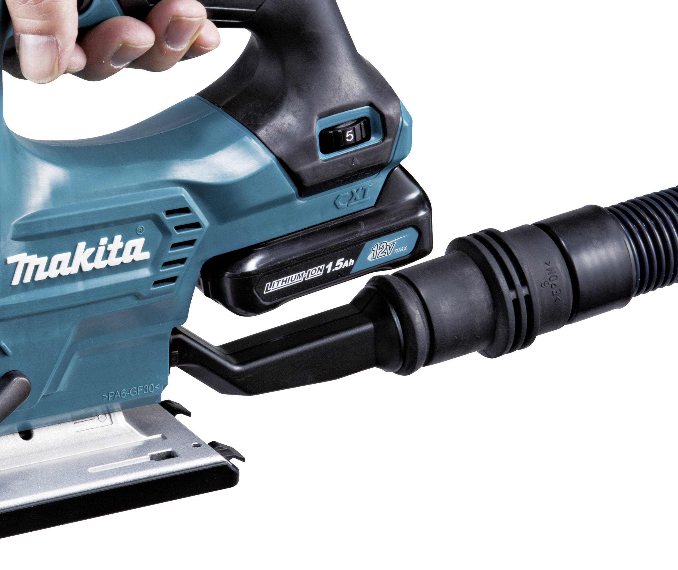 A hand is holding an electric saw with a hose connection for dust extraction. The saw is a Makita battery-powered model.