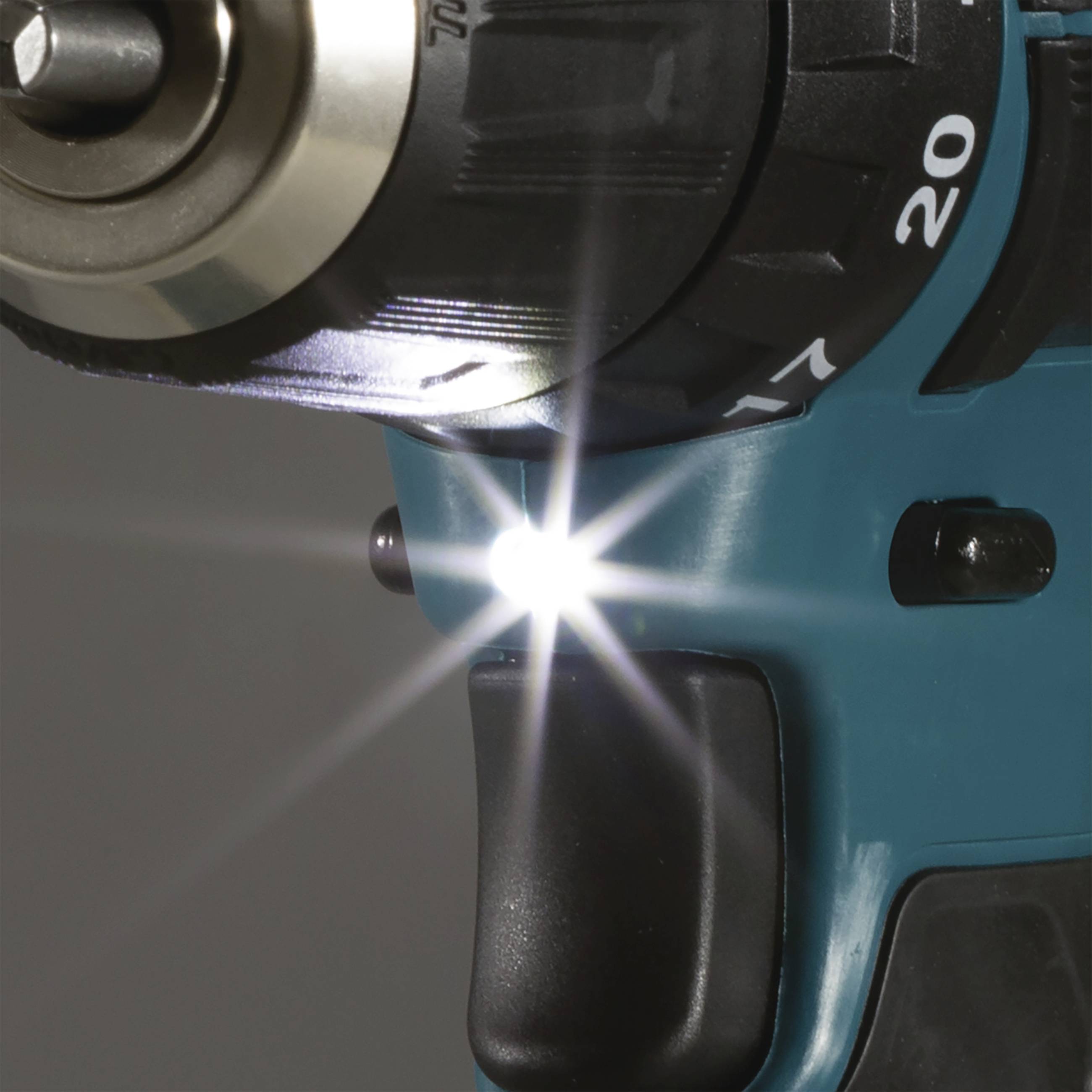 Close-up of a drill with an illuminating LED lamp that lights up the working surface.