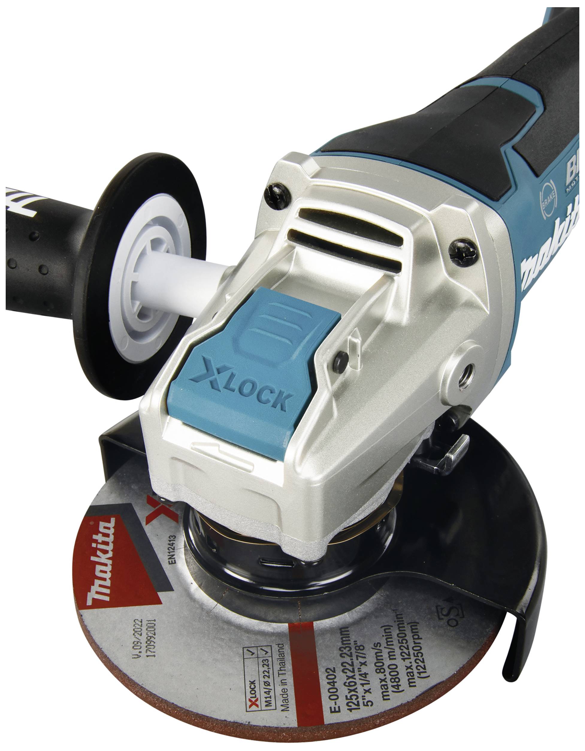 A Makita angle grinder with a disc. The device has a blue X-LOCK switch and a protective handle.