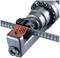 A hydraulic cutting tool is cutting a steel rod. The device has a red insert and is designed for precise work.