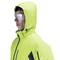 A person is wearing a bright green winter jacket with a hood and protective goggles. They are standing sideways and looking forward.