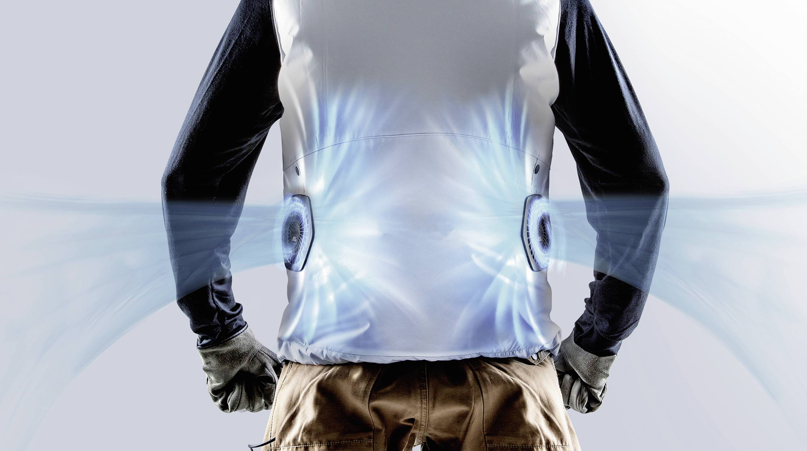 A person is wearing a vest with built-in fans on the sides, which generate blue air streams and provide ventilation.