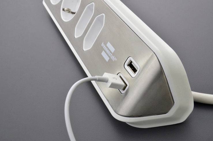 Multi-socket extension lead with USB ports, on a grey background, showcasing modern design and versatile connection options.