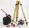 A yellow surveying tripod with accessories: a laser device, a target board, a measuring rod, safety glasses, and a transport case.