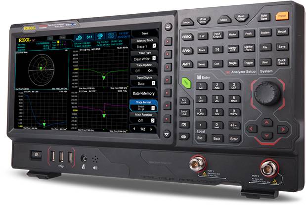 An oscilloscope with a colour display shows several graphs and measurement values. On the right are comprehensive control buttons and sockets.