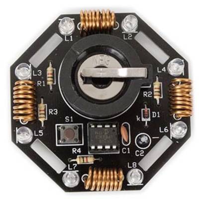 'Eight-sided electronic circuit board with copper coils, resistors, LEDs and a black central component with a switch.'