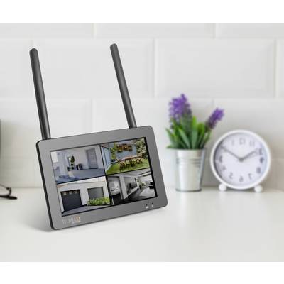 A screen with two antennae displays surveillance camera feeds, including a garden, a garage and a room. A clock is visible in the background.