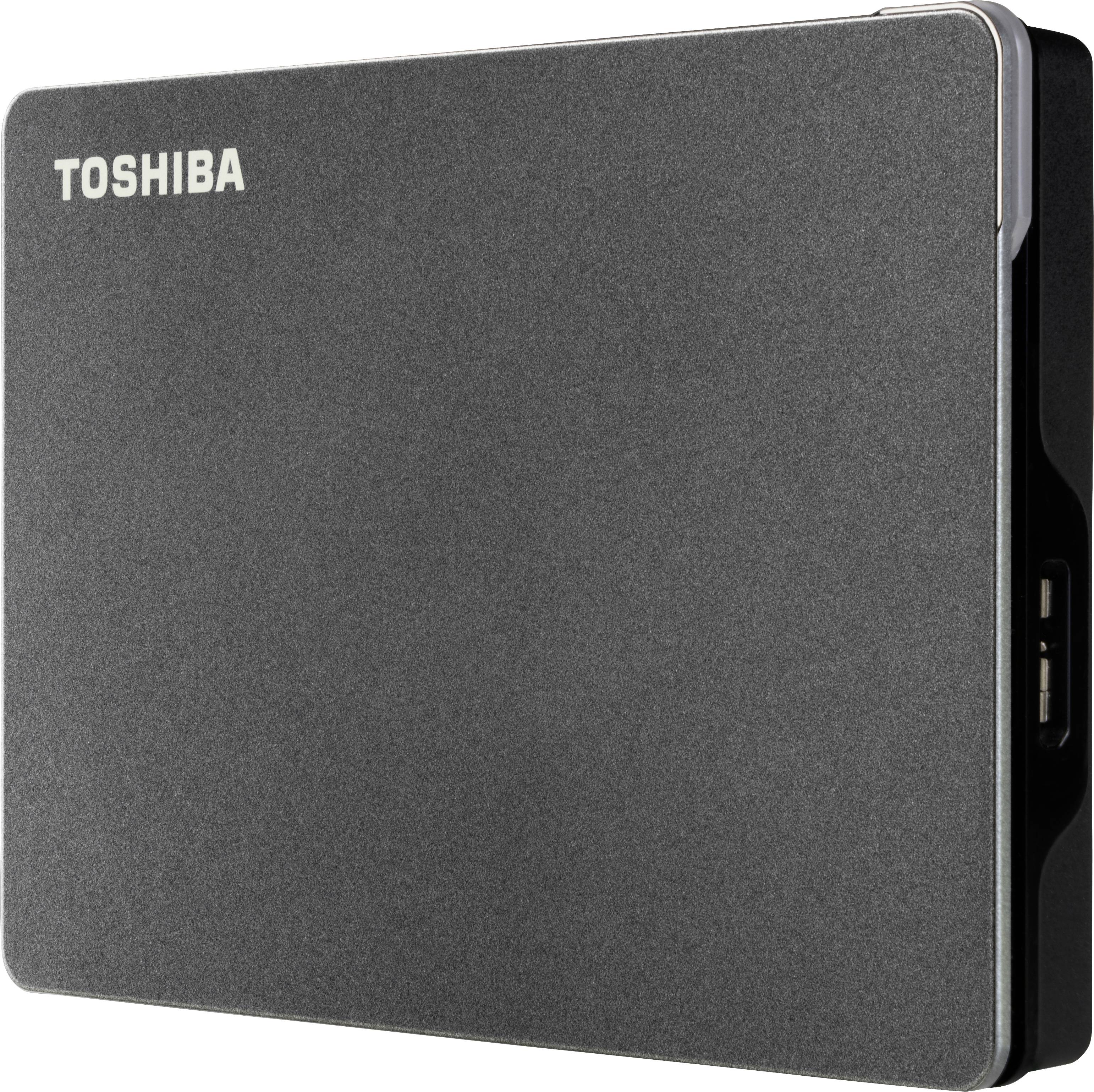 External black Toshiba hard drive with rounded corners, brand visible in the top left corner, USB port on the side.