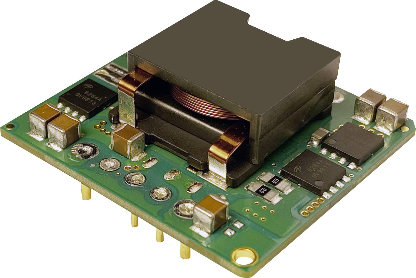 A green printed circuit board with electronic components, including inductors, chips and connectors, serves to regulate electricity in devices.