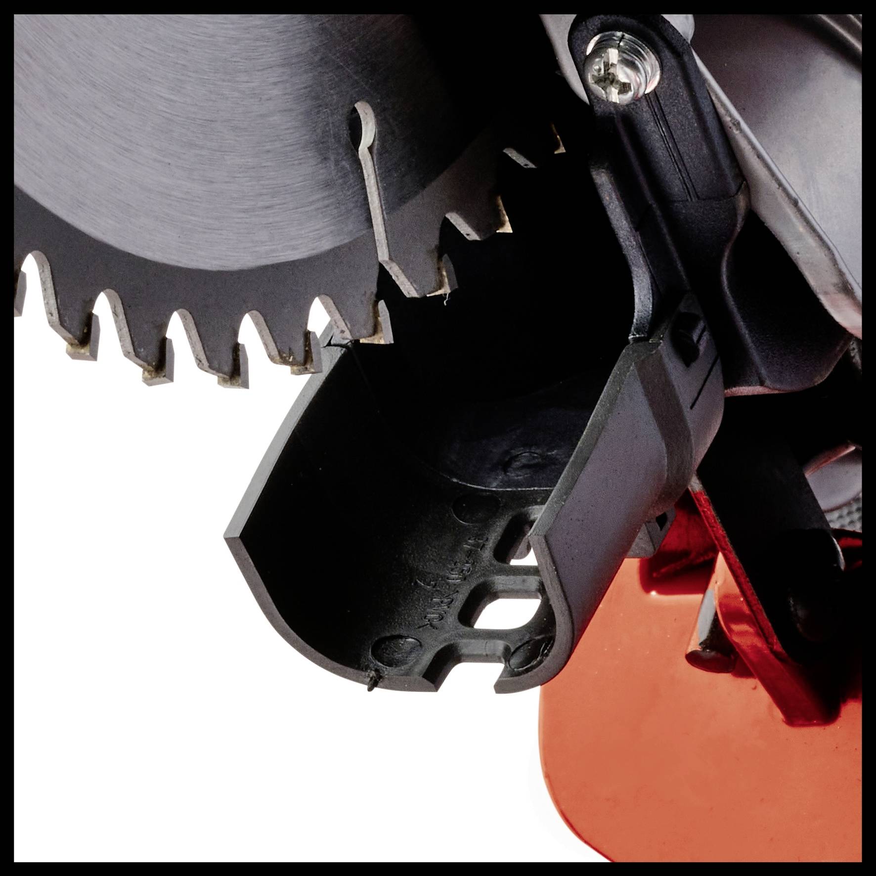 Close-up of a circular saw blade and its protective guard. The image depicts the sharp teeth of the saw in a work environment.