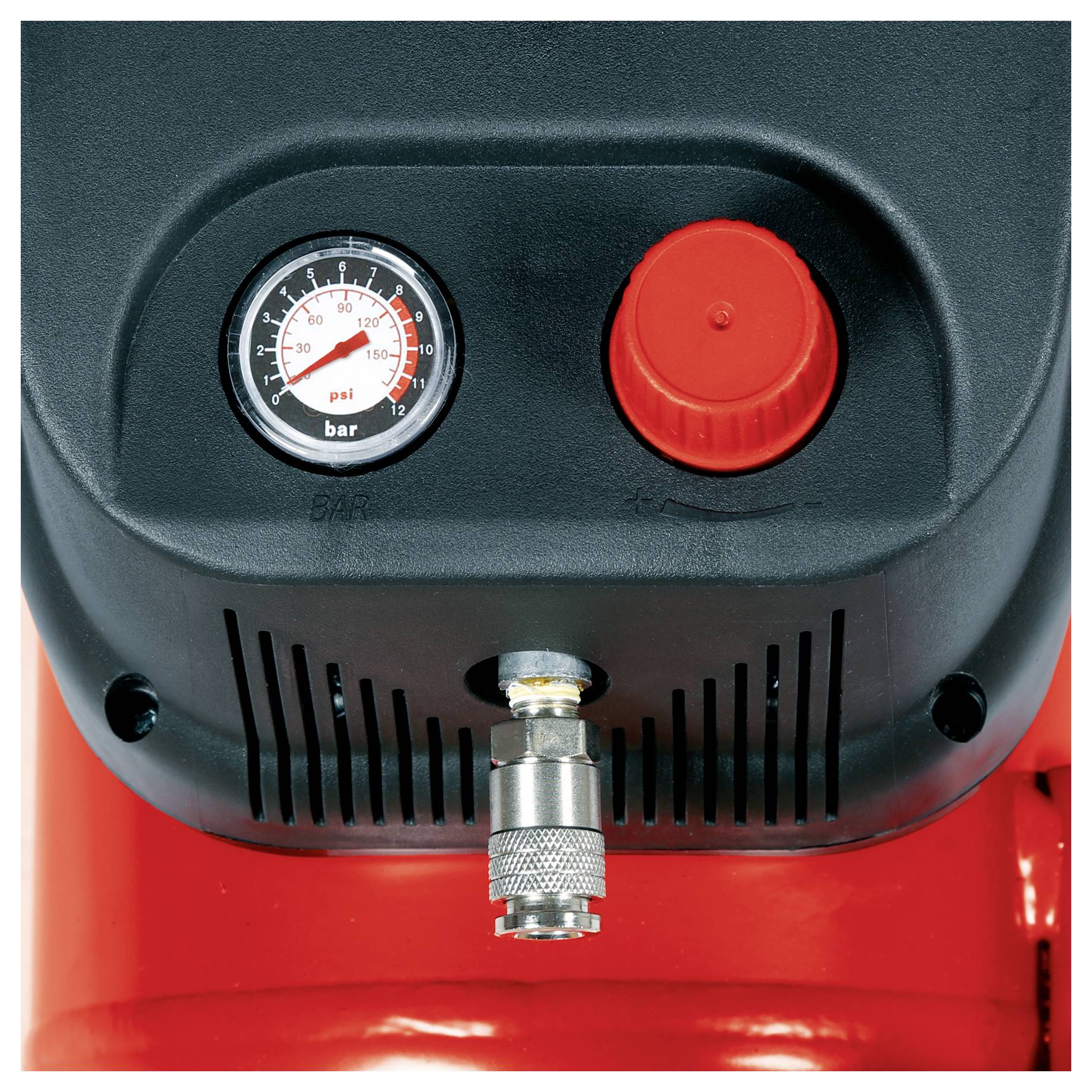 Close-up of an air compressor control panel with a pressure gauge, red knob, and hose connector on a red tank.